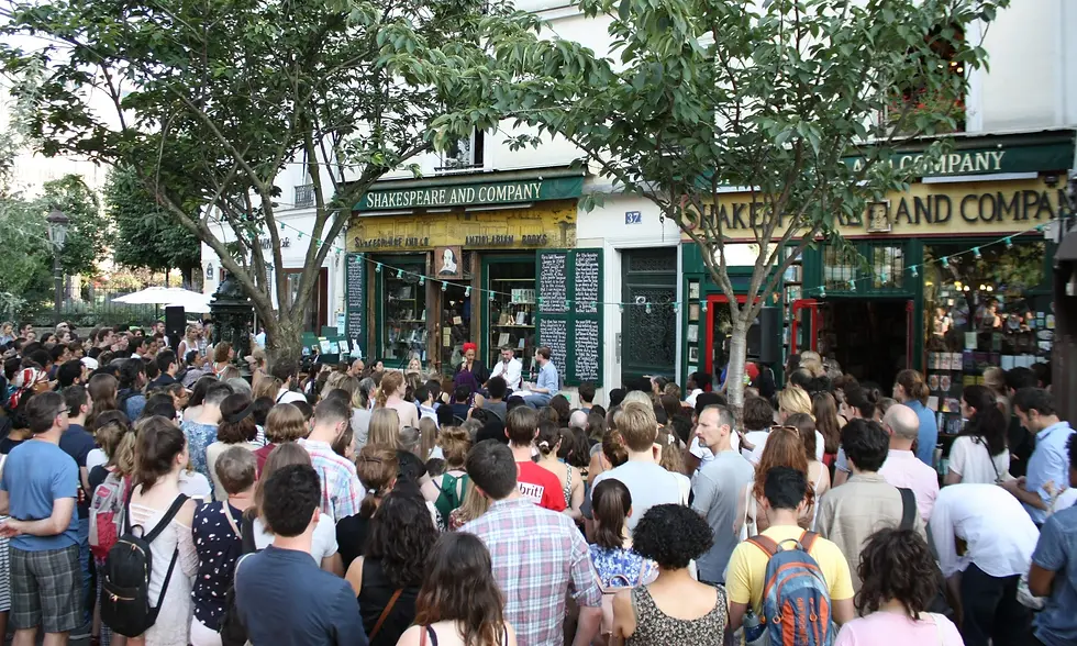 Shakespeare and Company, Rue de la Bûcherie. A summer evening reading spilling onto the pavement. Seventy years of literary history and still drawing a crowd.