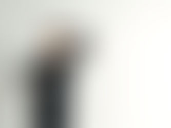 A model wearing an elegant black dress tailor made by Bunny Hopp