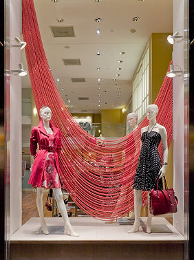 A Shimmerscreen installation providing a sleek backdrop and modern design element in a retail store, such as for a clothing o