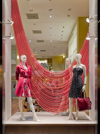 A Shimmerscreen installation providing a sleek backdrop and modern design element in a retail store, such as for a clothing o