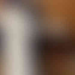 November Weight Loss Challenge Member measures their inches lost. The coach is wearing a long white jacket and stand behind the member holding a tape measure.