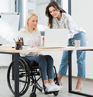front-view-woman-wheelchair-working-desk.jpg
