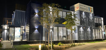 Container office building with exterior lighting at night in UAE