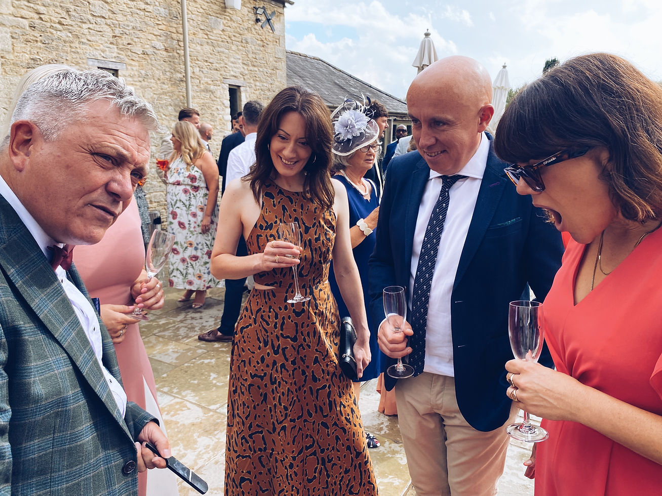 Wedding guests laughing and reacting to close-up magic by Brian Storey at Caswell House