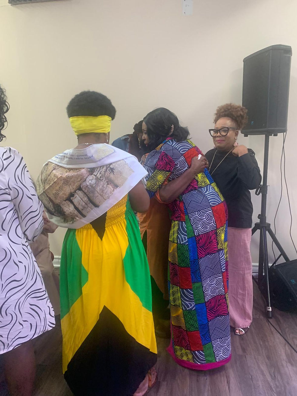 Marcia and a group of women in an embrace during a women's group session
