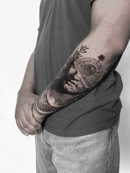 Tattoo of greek or roman statue eye in Black and White Realism by APZ in New York, USIn New York, APZ is a skilled tattoo artist trained by some of the best tattoo artists in the world. He specializes in classic realism tattoos using a modern black and white style, focusing on connected designs and full sleeve tattoos that enhance his clients’ style. His greek or roman sculpture eye tattoo on forearm speaks volumes with lifelike realistic details.