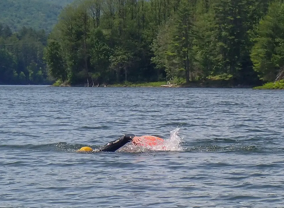 Swimmers wearing bright caps and using swim buoys are more visible to boaters on the water. Photo by Sheila Goss