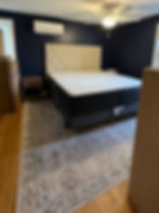 Freshly painted bedroom by Dirigo Paint Co. with upholstered headboard