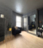 Dark painted interior walls by Dirigo Paint Co. with natural wood flooring