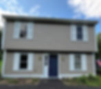 Freshly painted home exterior by Dirigo Paint Co. with dark front door