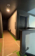 Light painted hallway with dark interior doors by Dirigo Paint Co.