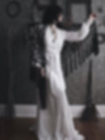 A woman wears the Widow's Web Shawl