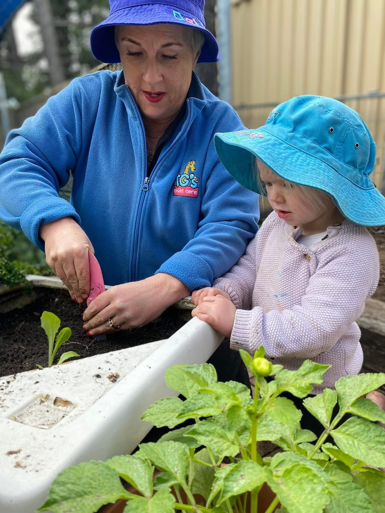 TG's Educator and child in the garden | TG's Child Care 