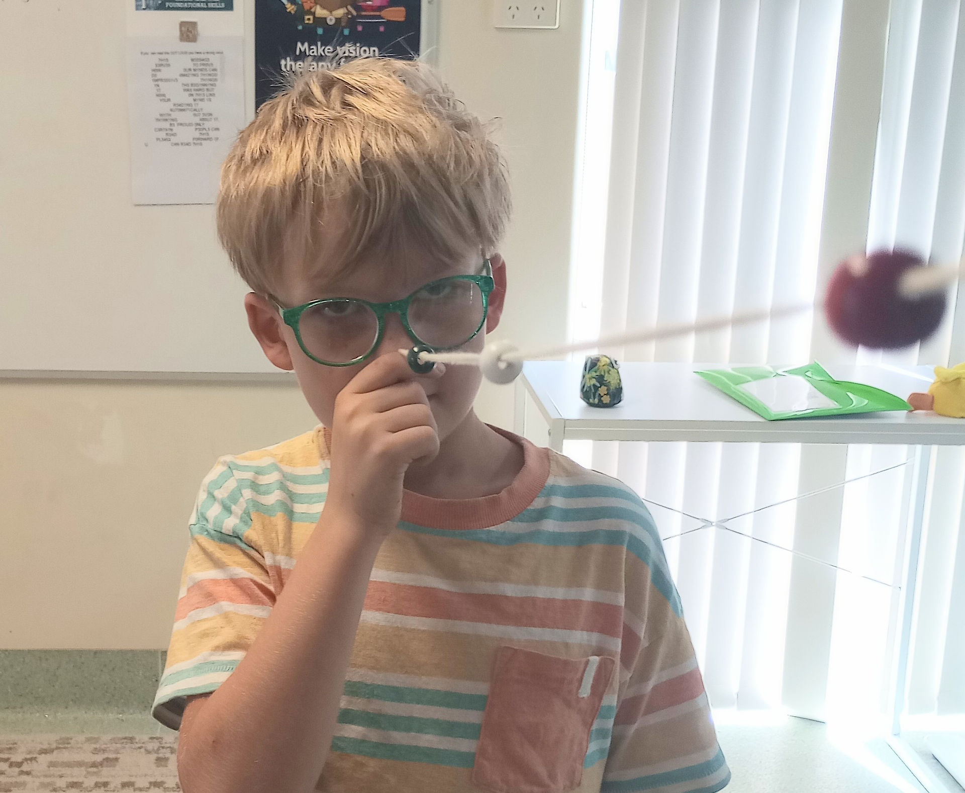 Edward doing brockstring training in vision therapy | Panoptic Vision