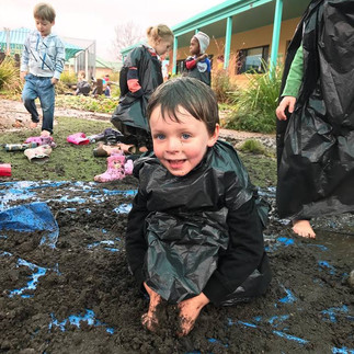 International Mud Day at TG's Armidale little boy playing with mud | TG's Child Care 