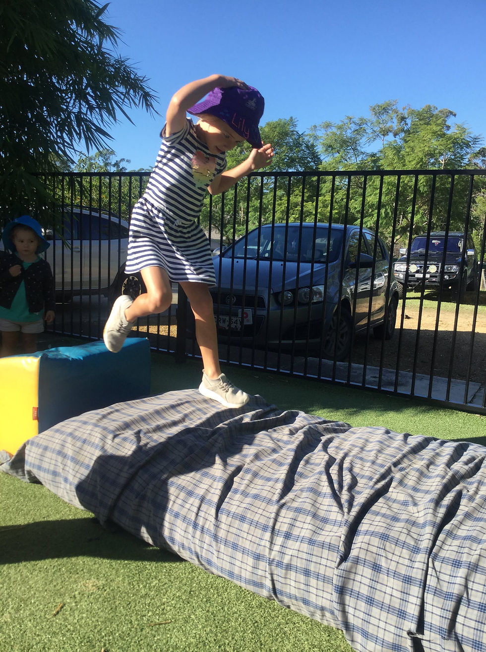 Toddler taking a leap in outdoor exercise