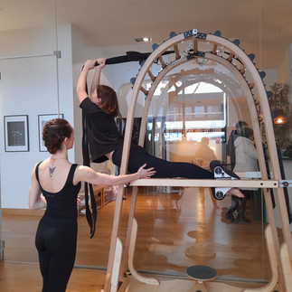 Estefania and Paloma demonstrating a back exercise on the Archway Gyrotonic | Brilliant-Online 