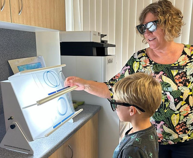 Julie helping Edward with 3D training in vision therapy | Panoptic Vision