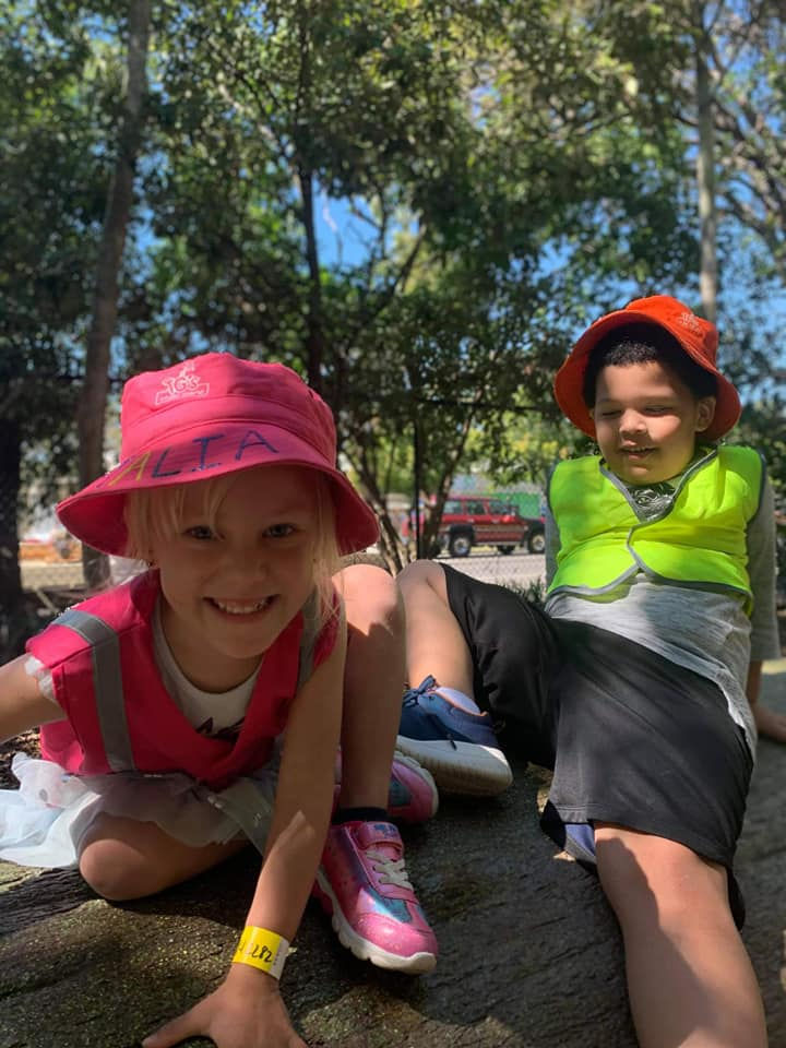 Two young children having fun on beach and bush kindee at TG´s Urangan
