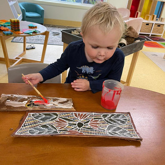 TG's hastings street toddler painting an aboriginal picture