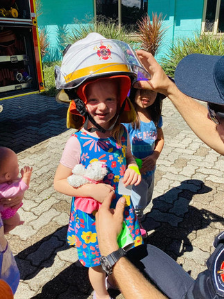 TG's Urangan firefighter visit little girl wearing fireman hat | TG's Child Care