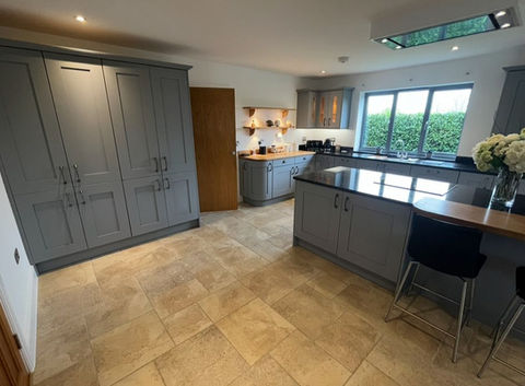 Modern kitchen with gray cabinets, an island, and a tiled floor