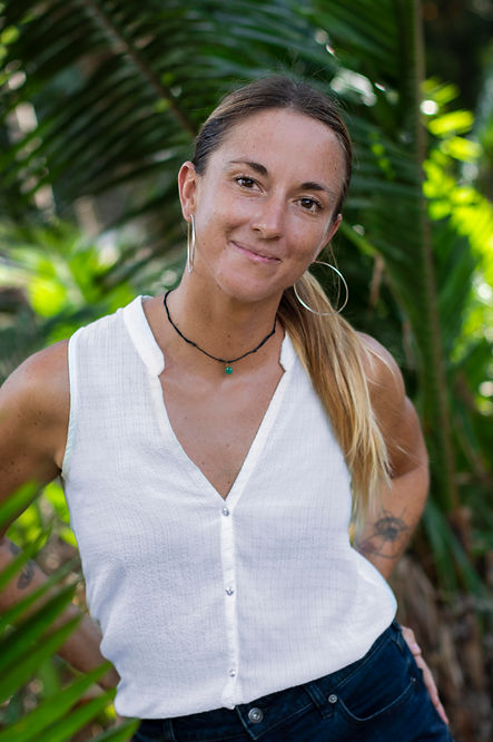 Woman smiling while on a beach vacation during a Corporate Wellness Retreat with Nomad Inc Custom Adventure Travel