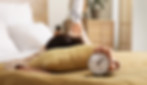 Woman with alarm clock lying on bed, closeup.jpg