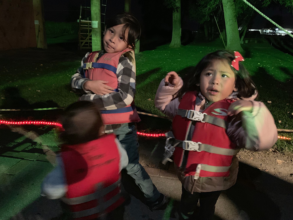 Kids getting ready for the Provo River Halloween Cruise in life jackets.
