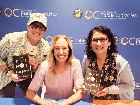 Books and big smiles at the OC Library sponsored literary event featuring author Kaira Rouda. Blog post by Renee Coloman. RCwriter-pen-ink-suffering.com