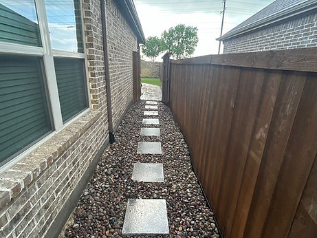 Side stepping stones in river rock walkway