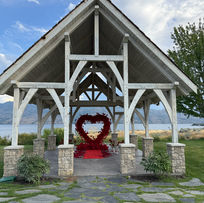 A romantic proposal at Sanctuary Gardens in West Kelowna featuring a rose-lined walkway, lush gardens, and lake views—styled to perfection by Pickadilly’s Proposals.