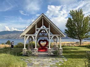 “Private proposal setup at Sanctuary Gardens in Kelowna featuring Pickadilly’s oversized red flower heart, rose petals, and gazebo styling
