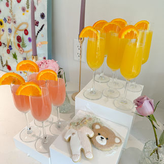 Chilled welcome mimosas with fresh orange juice and Frind Brut served at a lakeside baby shower in West Kelowna.