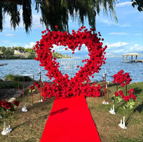 Garden-style red floral heart proposal setup at The air bnb in Kelowna, surrounded by vineyards and Okanagan Lake views.