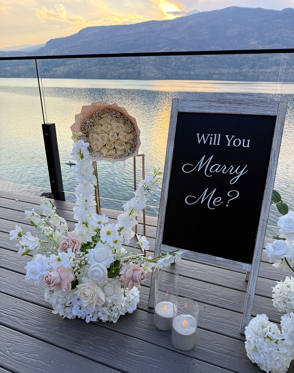 Romantic proposal sign and fresh bouquet styled with Real Touch flowers at an intimate Kelowna Airbnb engagement.