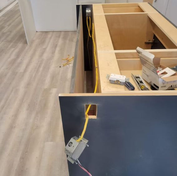 Kitchen electrical wiring and switch installation beside cabinet framing