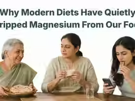 Infographic titled "Why Modern Diets Have Quietly Stripped Magnesium From Our Food" showing three main causes: soil depletion from intensive farming, food processing that removes magnesium-rich bran and germ, and reliance on refined grains. The graphic contrasts a plate of processed foods (white bread, polished rice, soda) low in magnesium with a plate of whole foods (leafy greens, nuts, seeds, dark chocolate, legumes) high in magnesium. Magnesium decline percentages included: 80–90% lost in refined flour, up to 50% lost in cooked vs raw greens. Visual cues include downward red arrows and a magnesium molecule symbol.