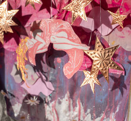 Pink mermaid surrounded by gold textures star paper cut-outs