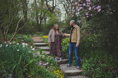 Couple walking down steps surrounded by flowers and woodland, Jo-Billington Wedding Photographer Yorkshire