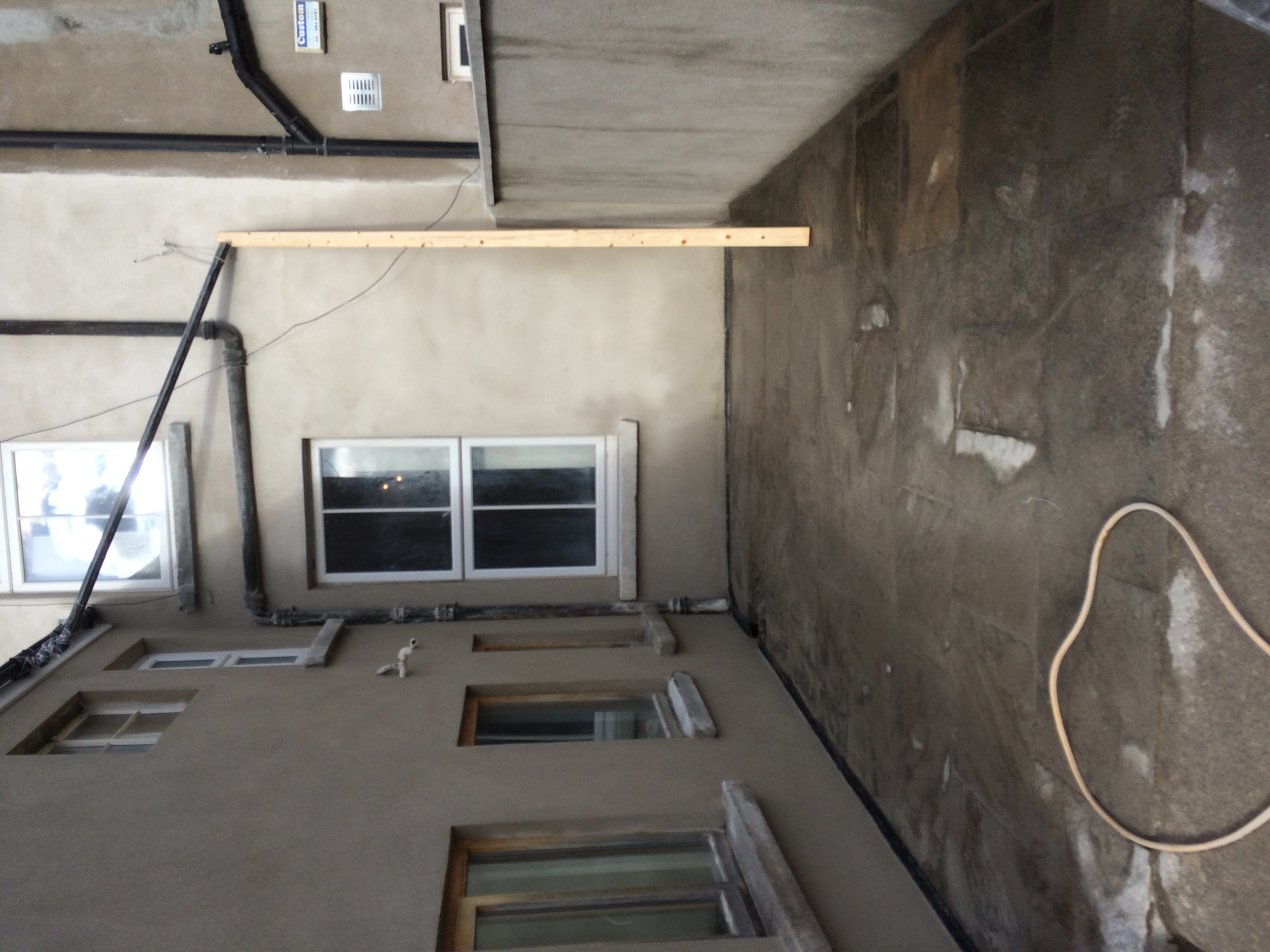 External brick wall after application of lime render Property Repair Guys 365