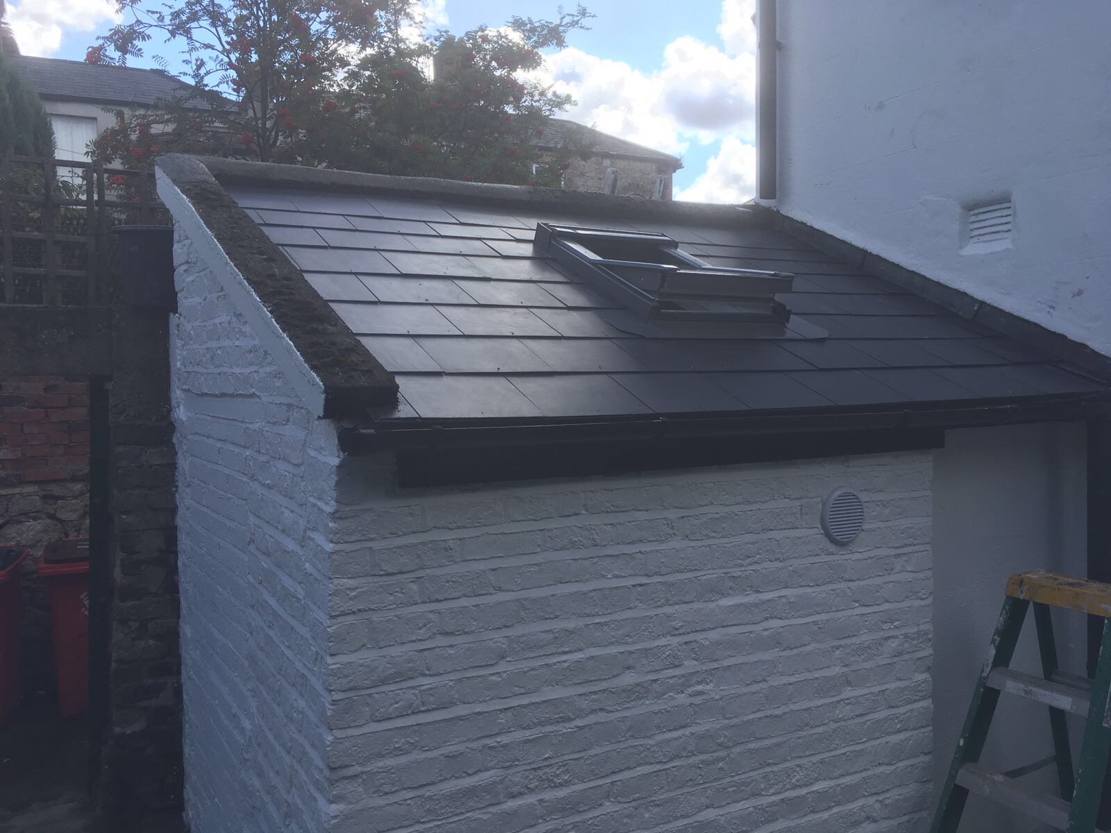 Property Repair Guys 365 Roofing with new slates and installed velux window and white paint finish