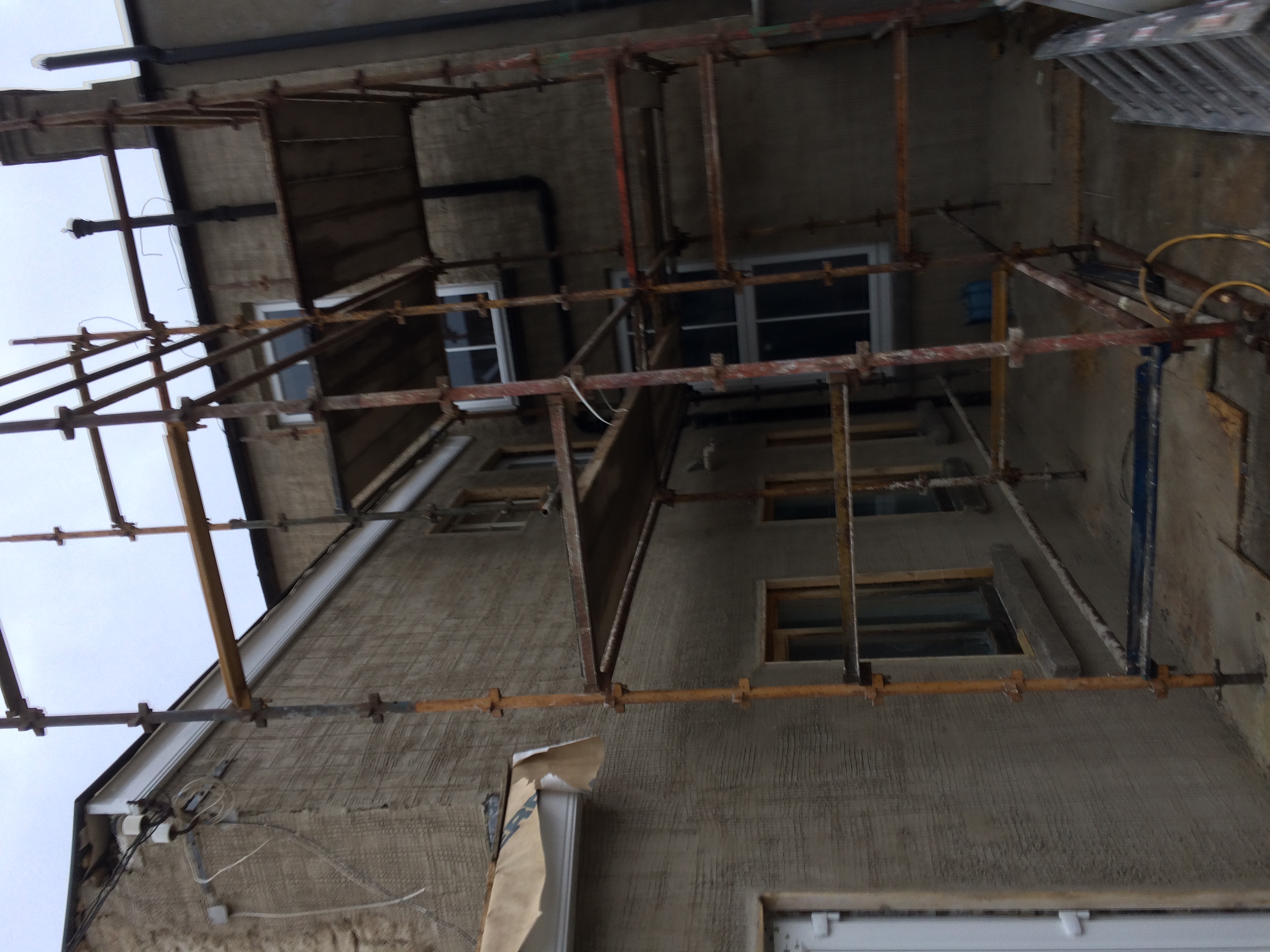 External brick wall during repair and application of lime mix render Property Repiar Guys 365