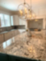 Modern kitchen with marble countertop by Naperville Plumbing Company.