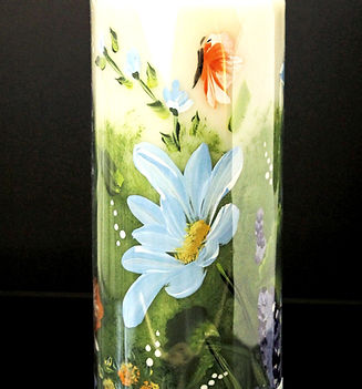 daisy garden painted on to a candle