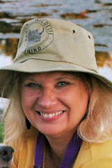 image of woman smiling wearing a hat