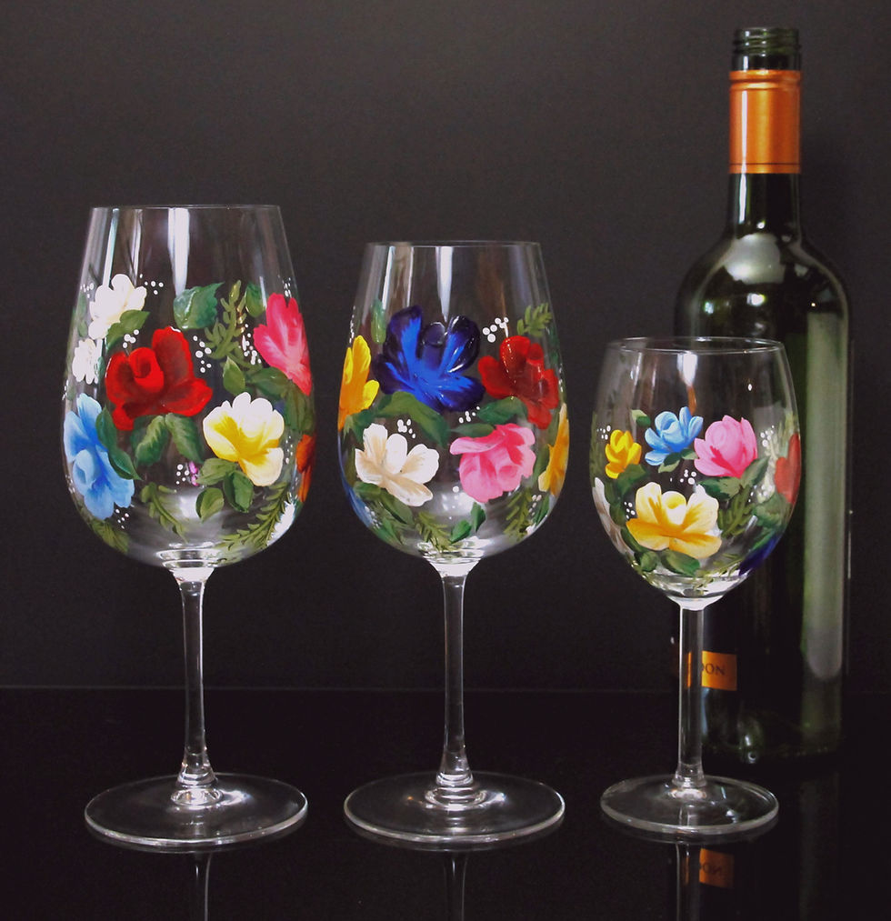 Close-up view of a hand-painted wine glass with vibrant sunflower design