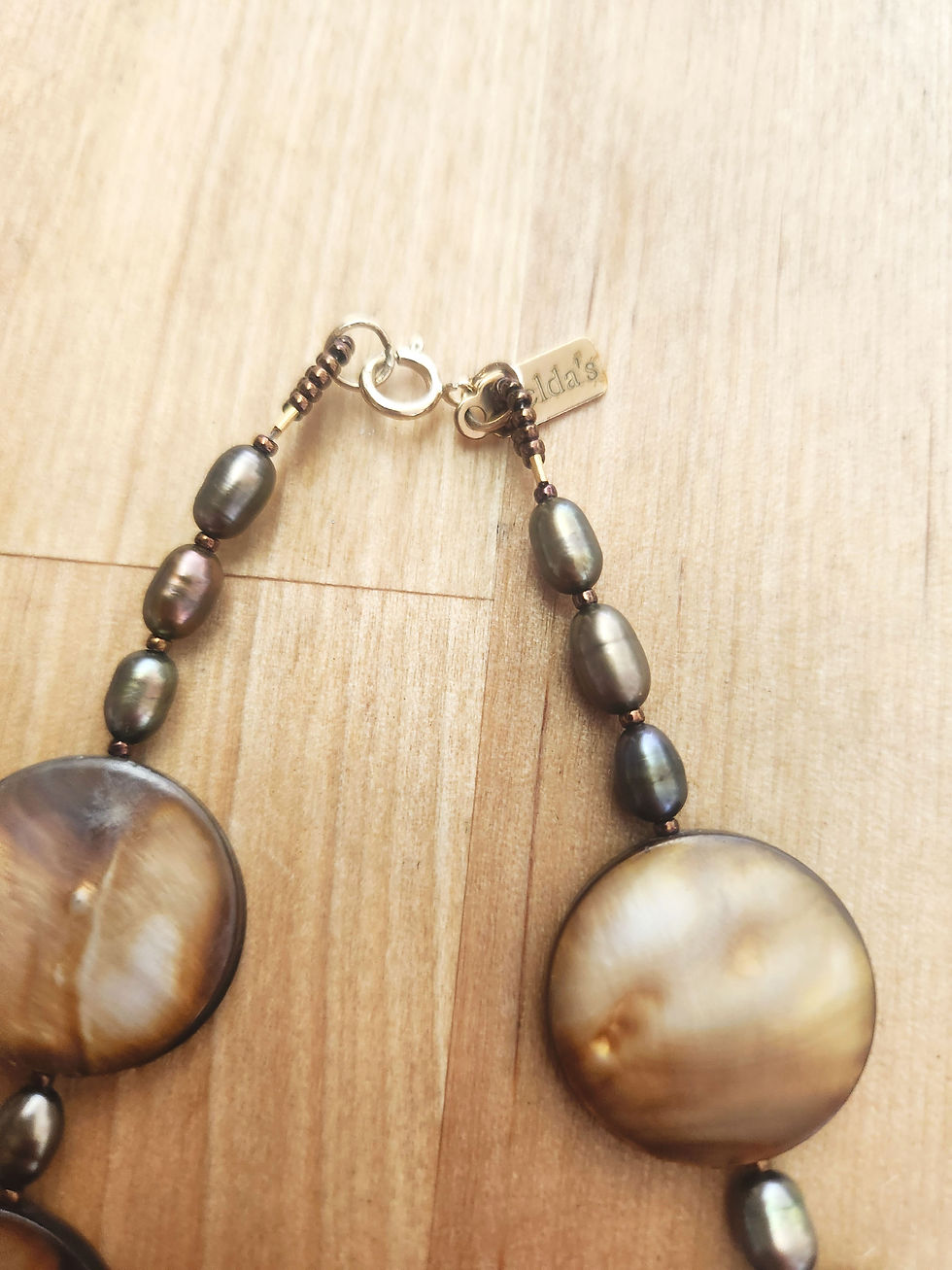 Thumbnail: Mother of Pearl, chocolate pearl, and 14k gold necklace. 