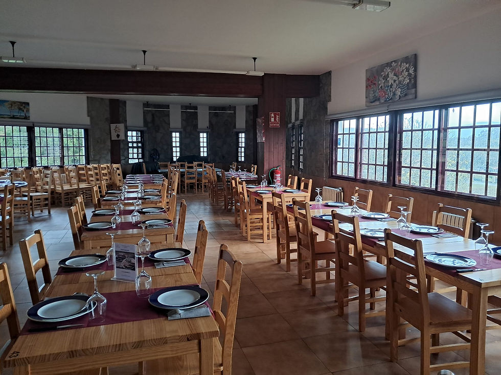 Eye-level view of a cozy dining area with wooden tables and warm lighting