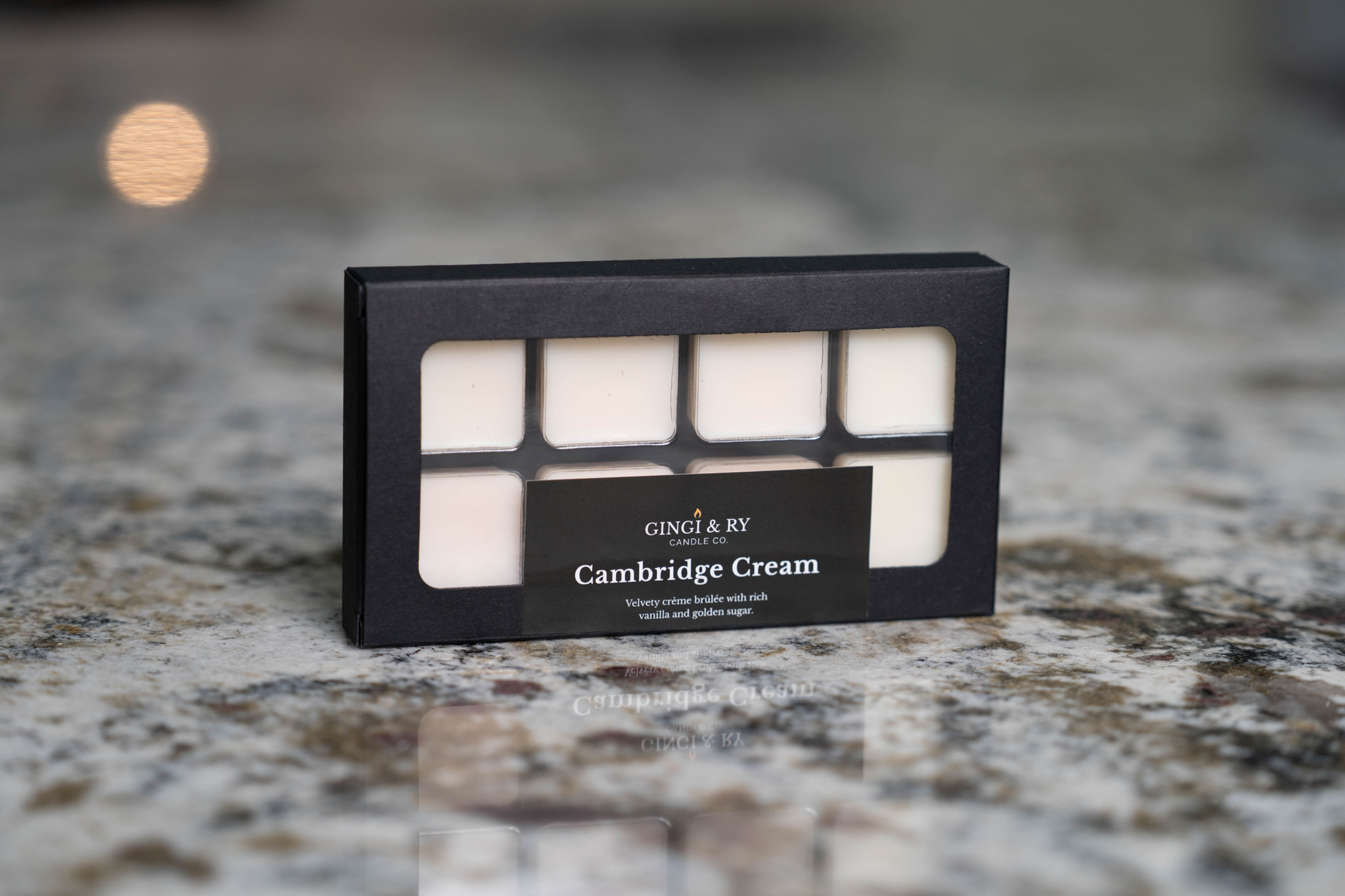Styled photo of Styled photo of cambridge cream wax melts in a cozy space with mat Cream wax melts from Gingi & Ry Candle Co.